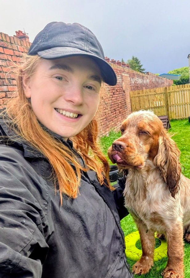 Smiling dog trainer with a spaniel